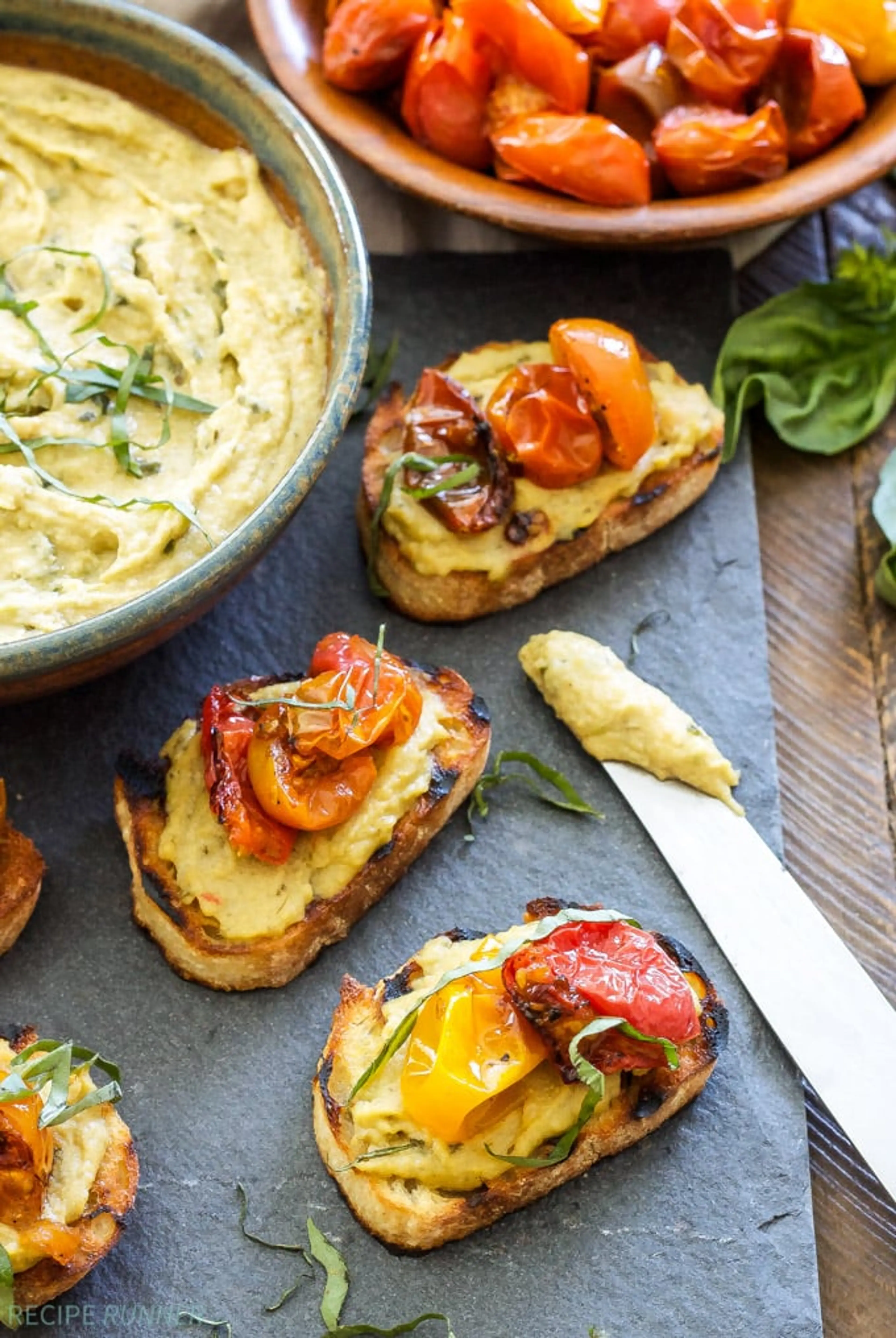 Basil Pesto Hummus and Roasted Tomato Crostini