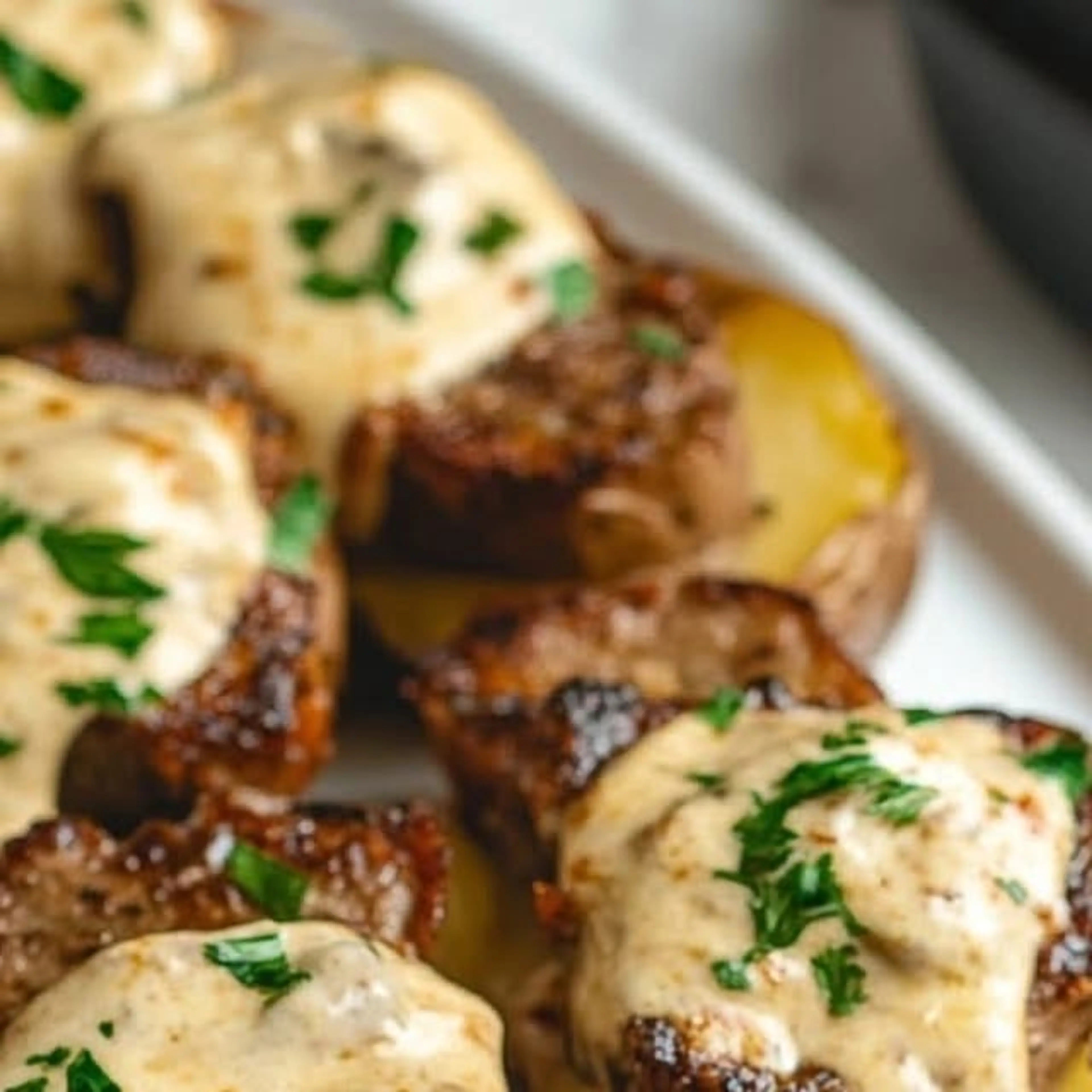 Steak-stuffed Baked Potatoes with Parmesan Cream Sauce