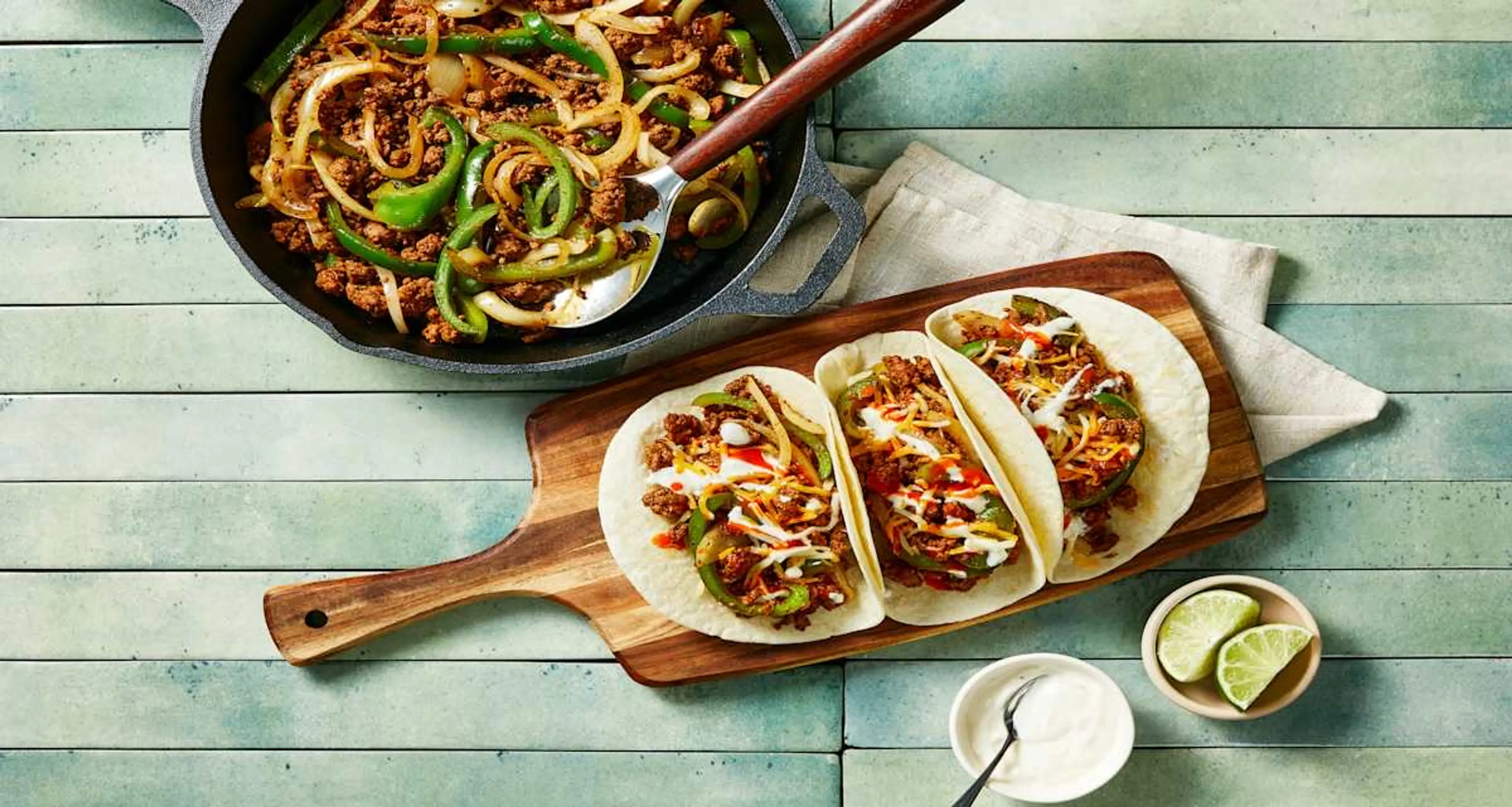 Ground Beef Skillet Fajitas with Lime Crema, Cheese & Hot Sa