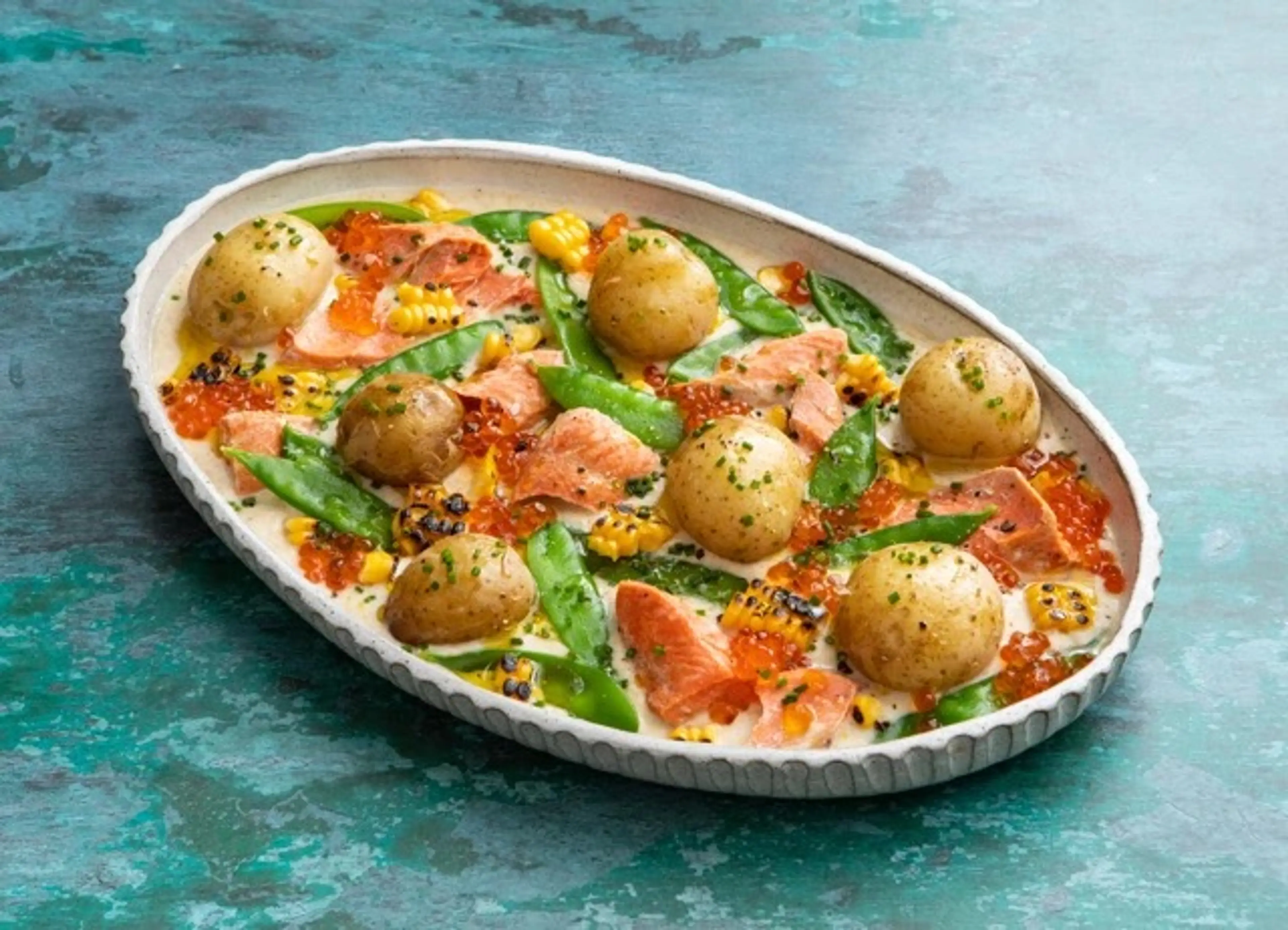 Salmon, mangetout and baby potato salad with a curried corn
