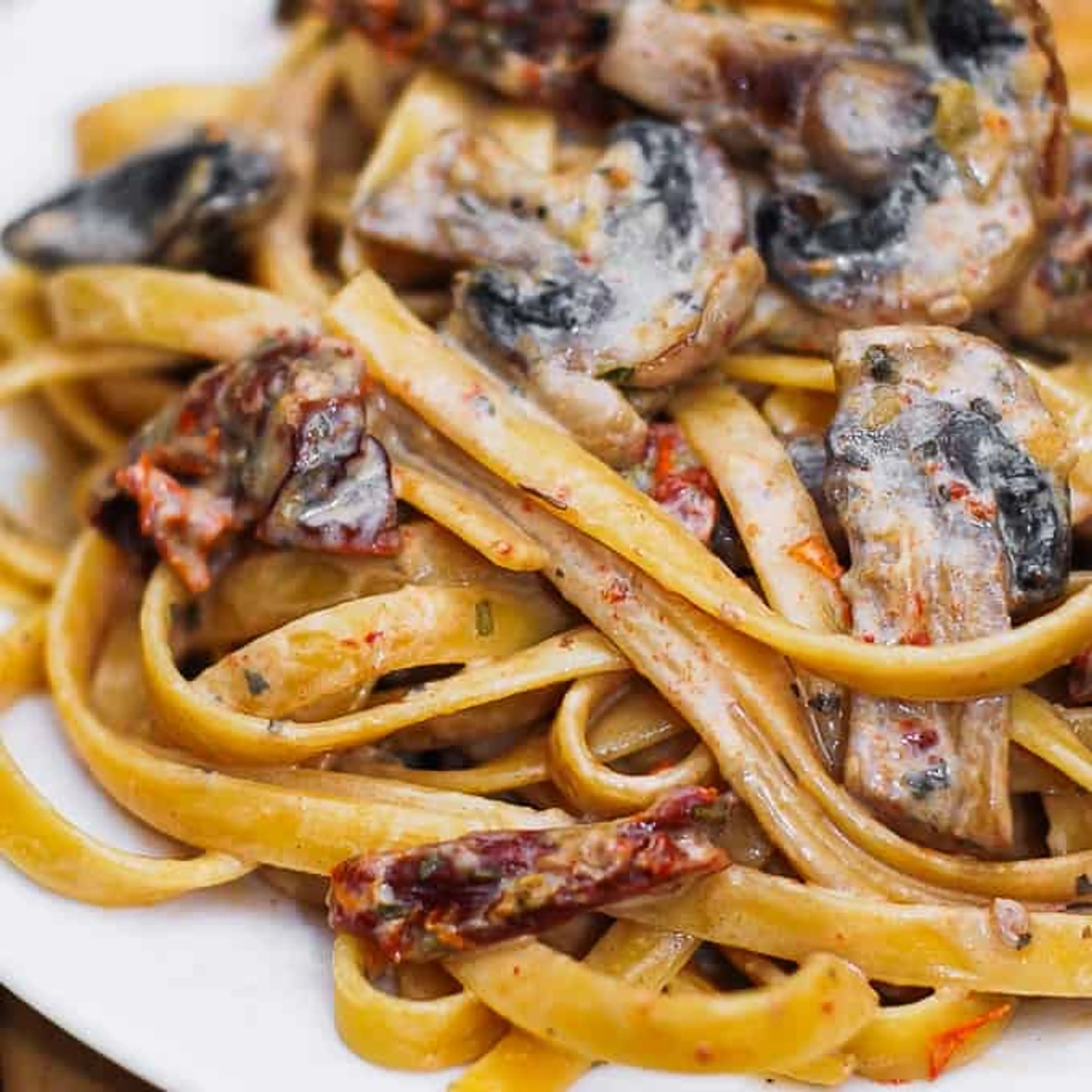Sun-dried tomato and mushroom pasta in a garlic and basil sa