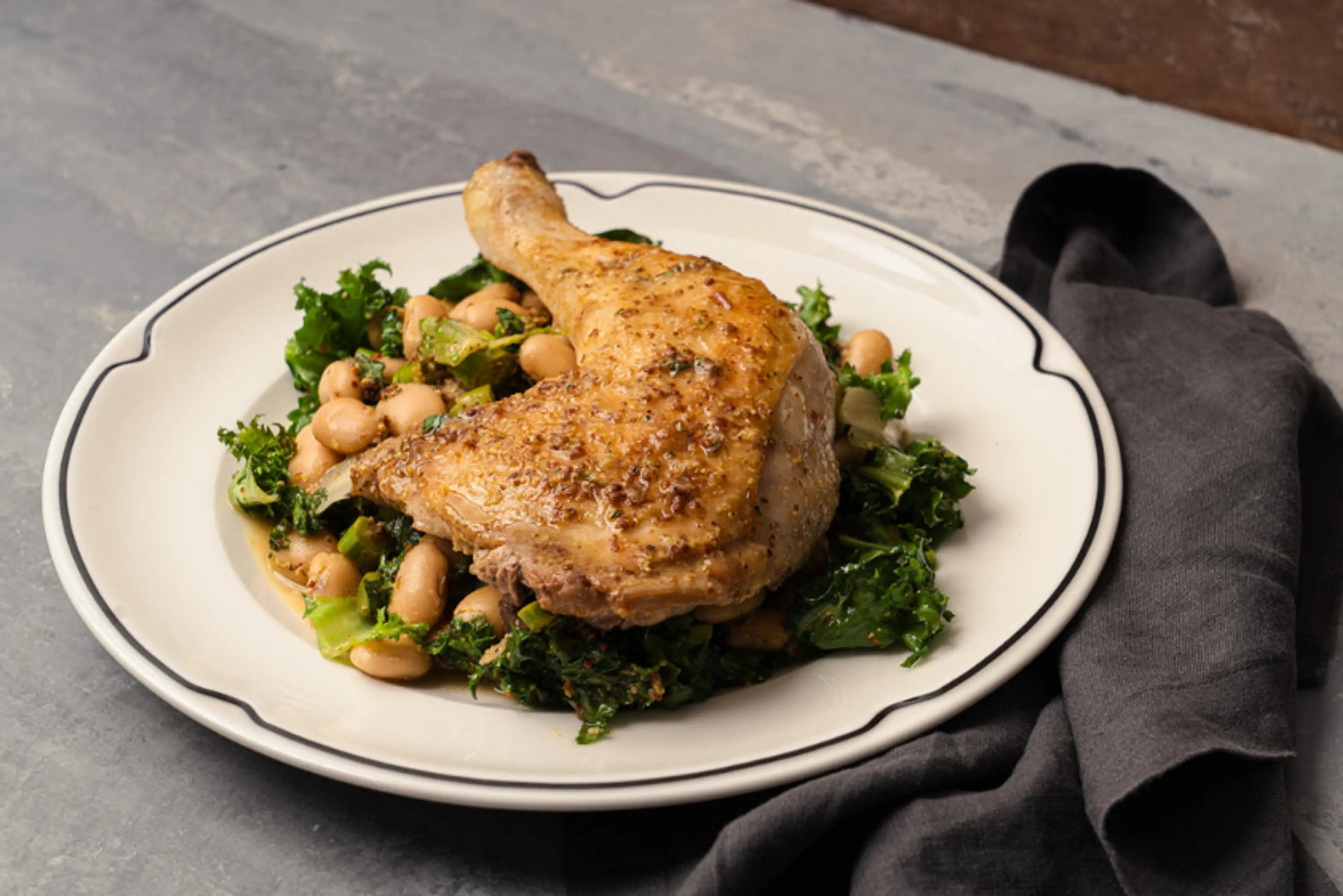 Pan roasted chicken leg with butter bean and asparagus salad