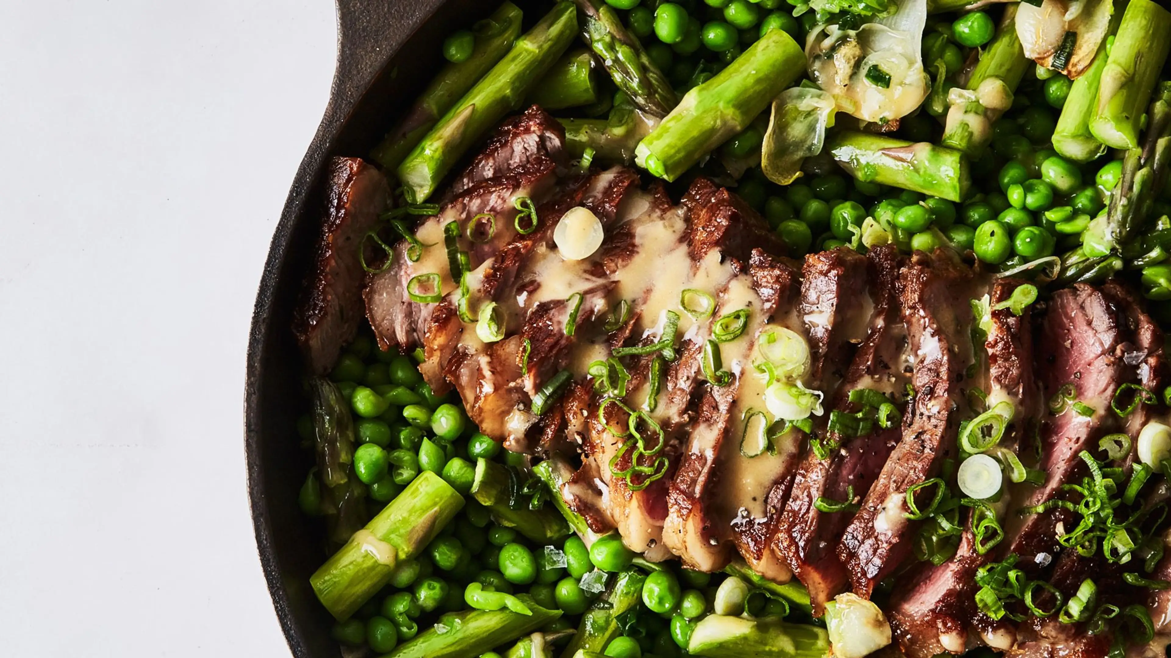One-Skillet Strip Steak with Asparagus, Peas, and Spicy Must