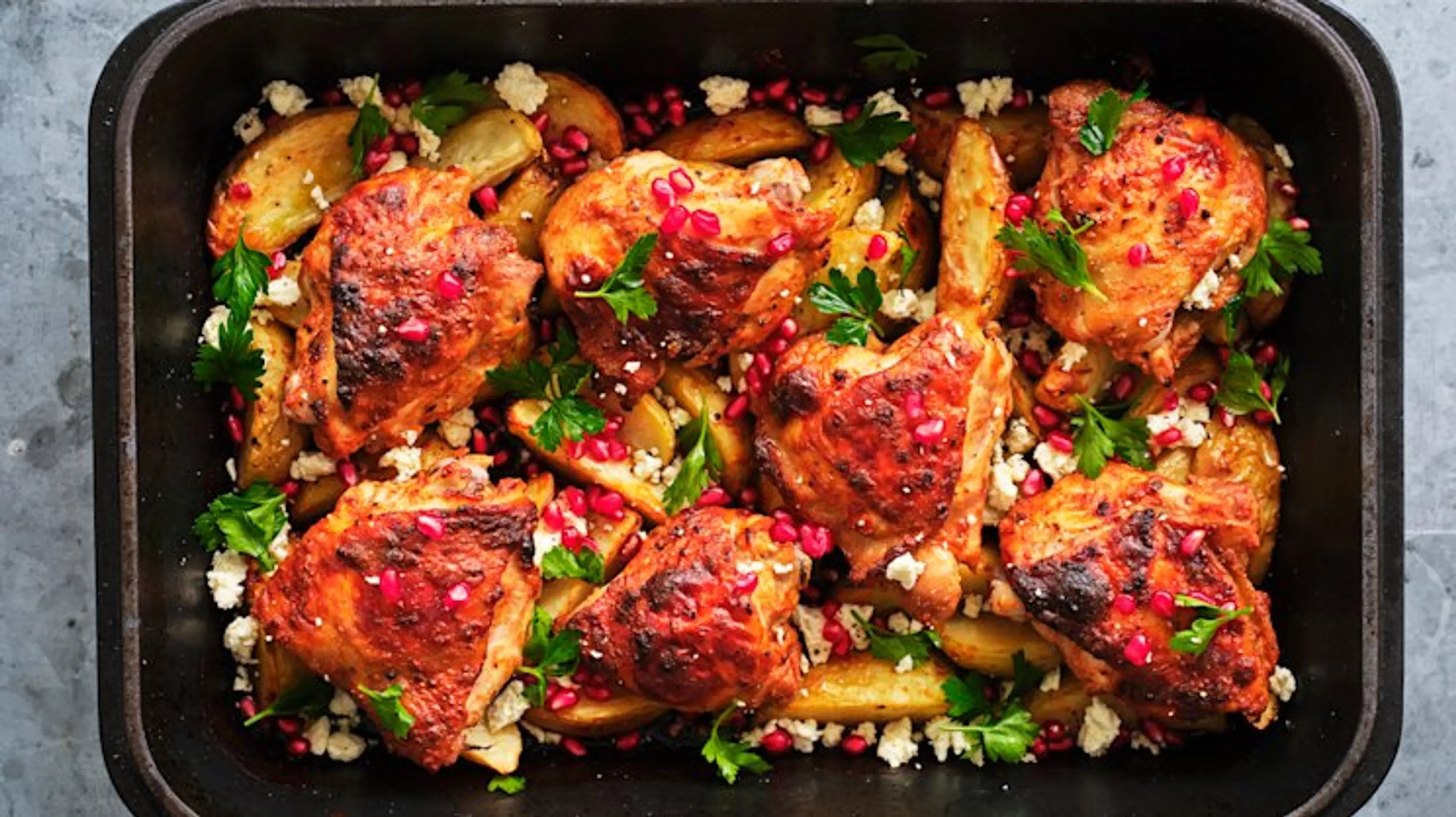 Yoghurt-marinated chicken w/potatoes, feta, pomegranate