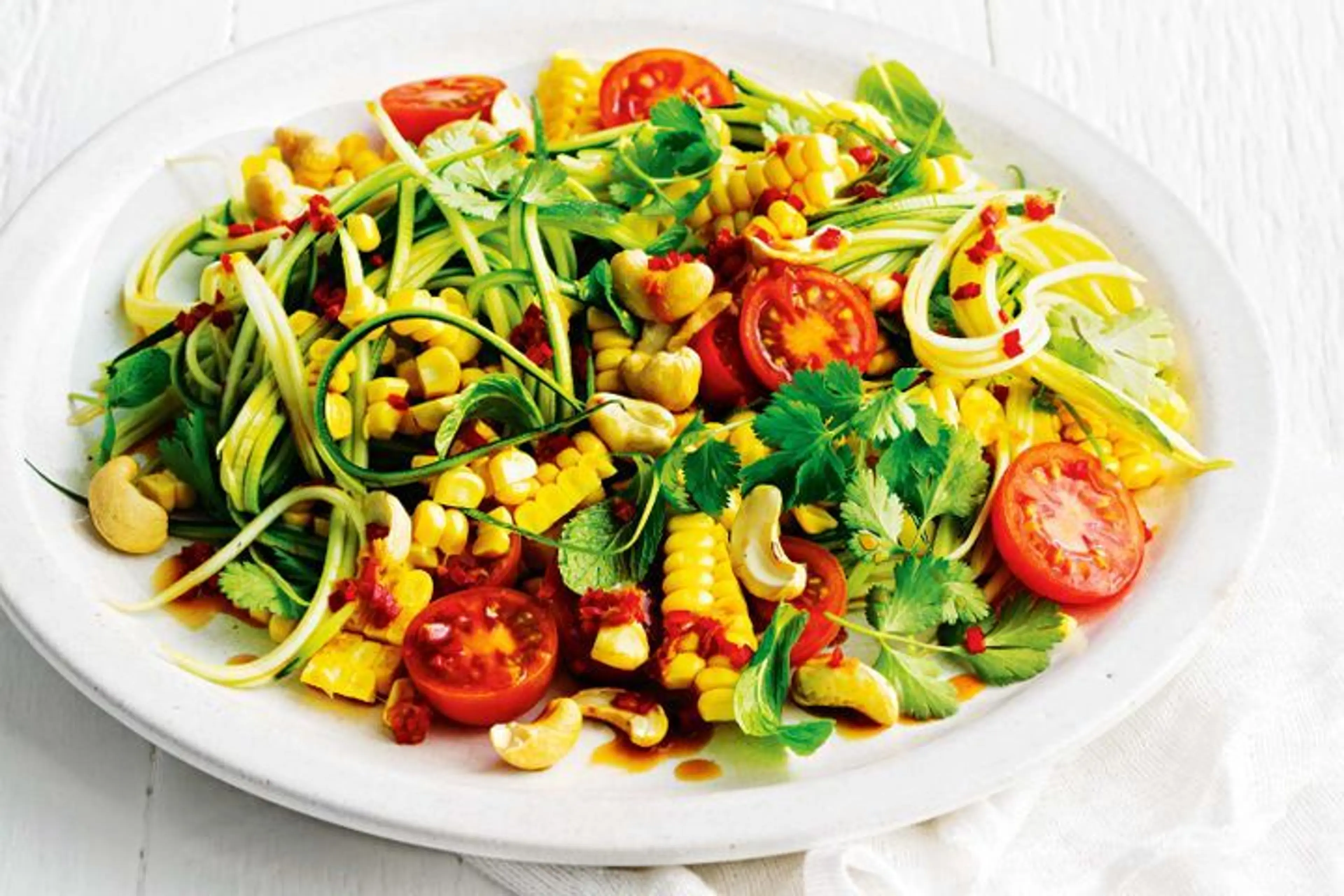 Zucchini noodle salad with herbs, cashews and chilli