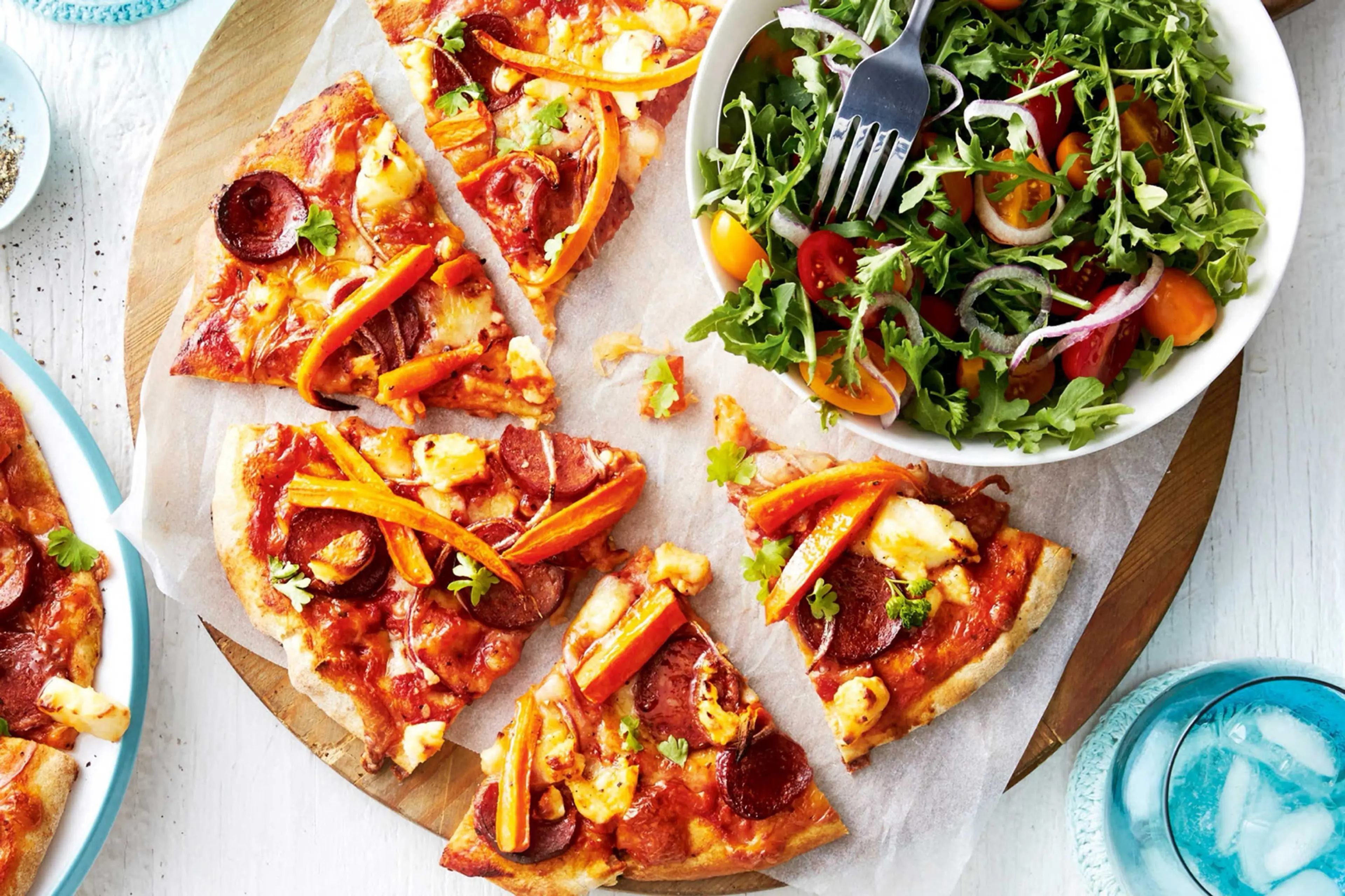 Chorizo and carrot pizza with rocket salad