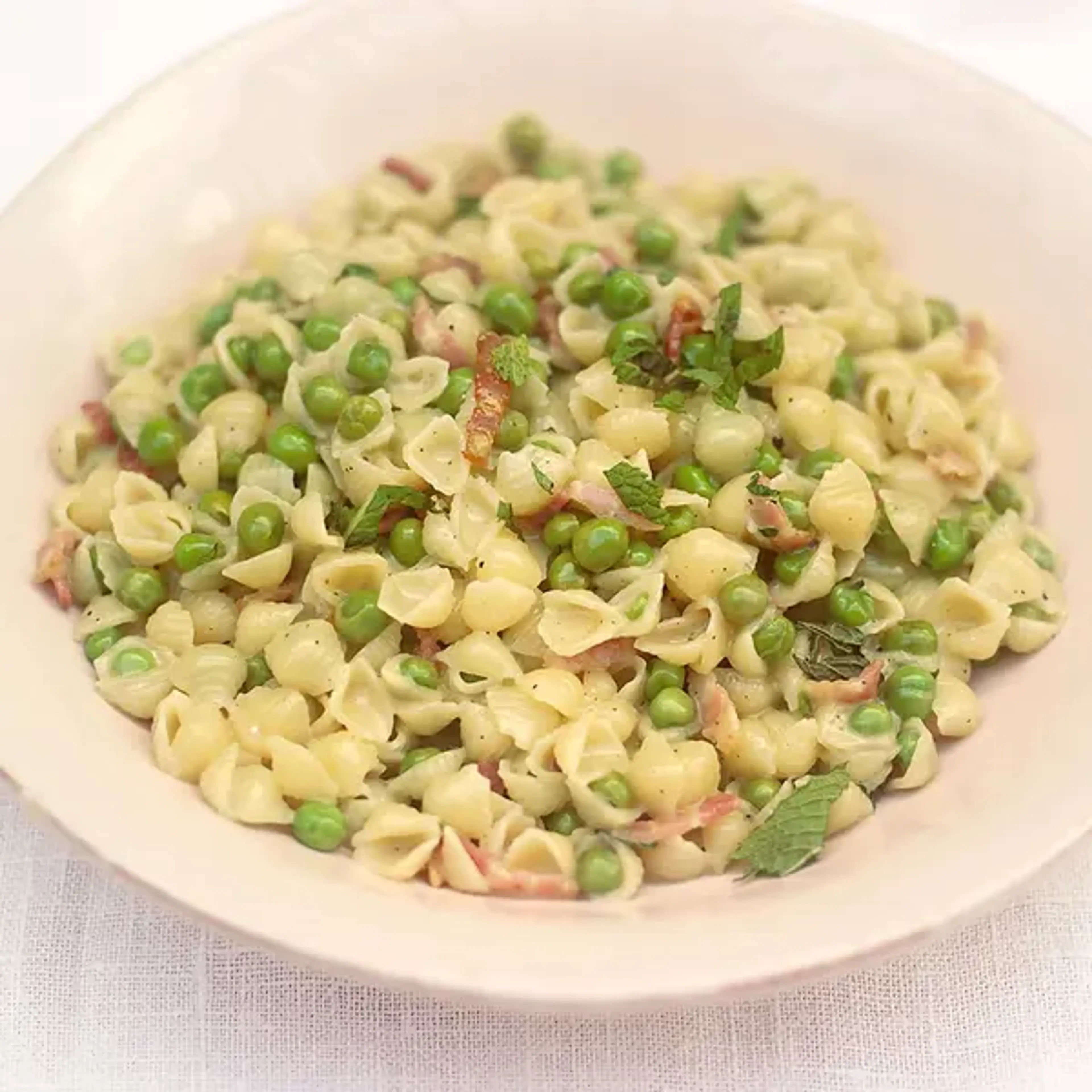 Mini shell pasta with a creamy smoked bacon & pea sauce