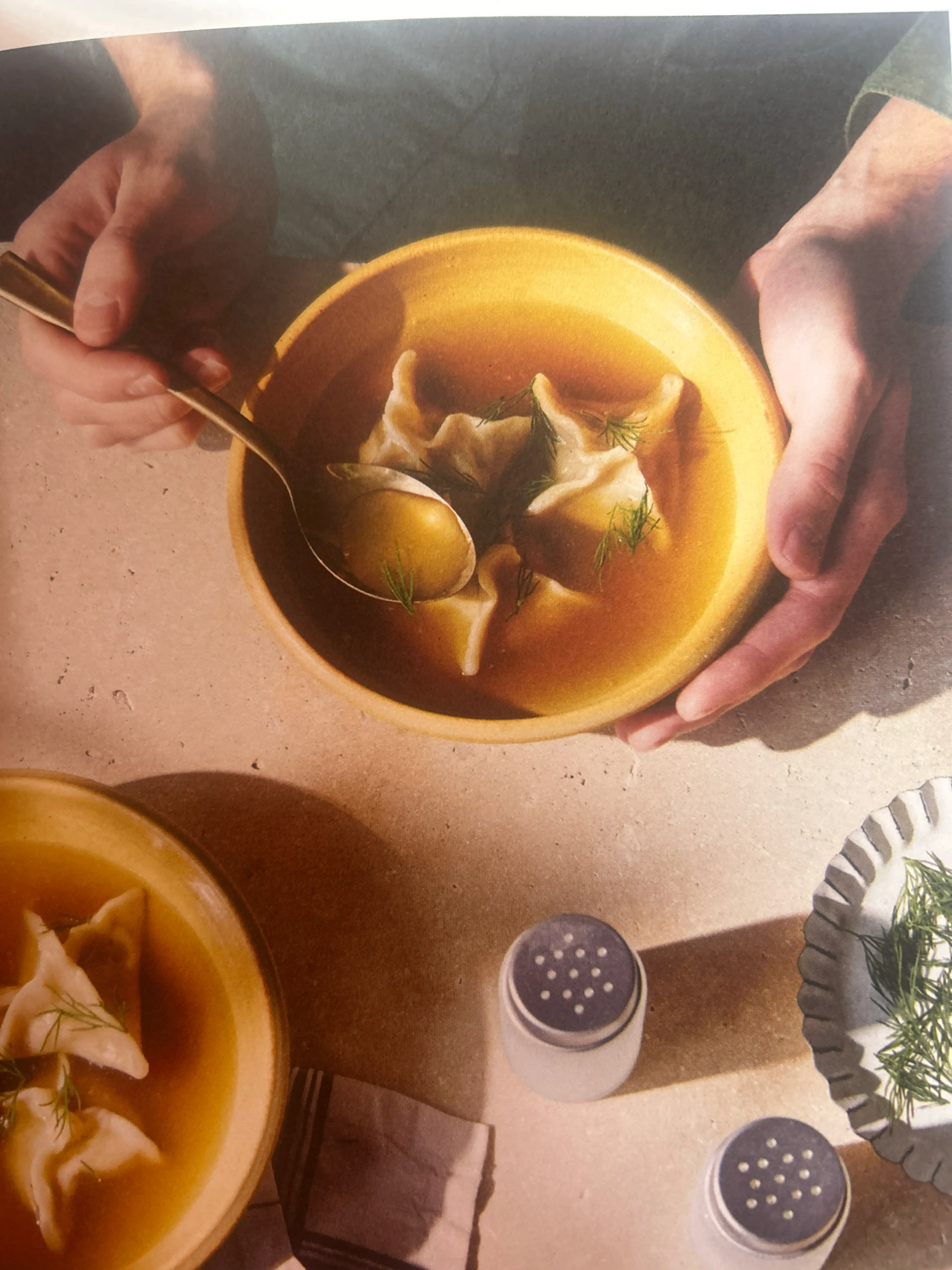 Fish and dill pierożki dumplings in rosót broth