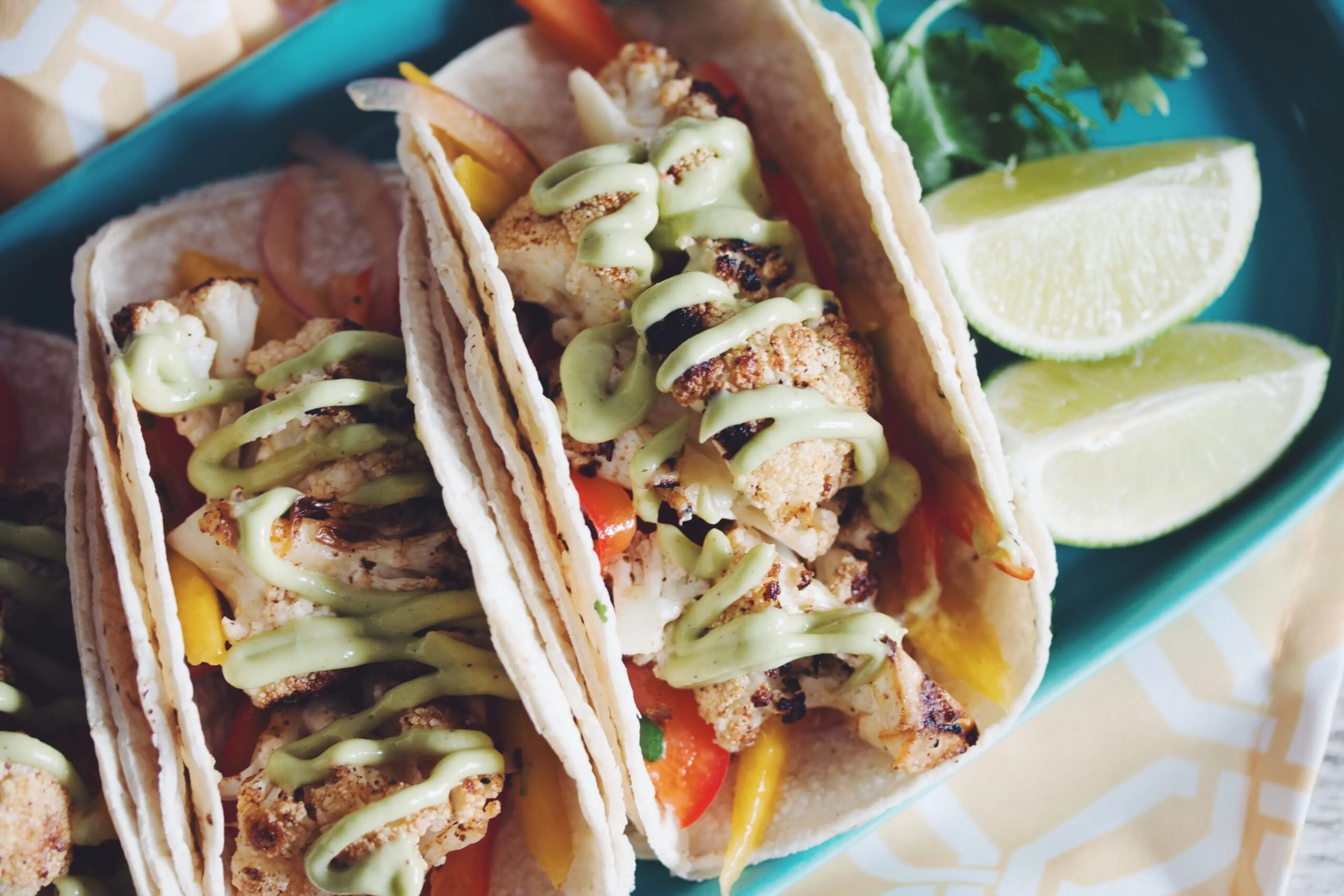 grilled cauliflower tacos with mango slaw & avocado crema