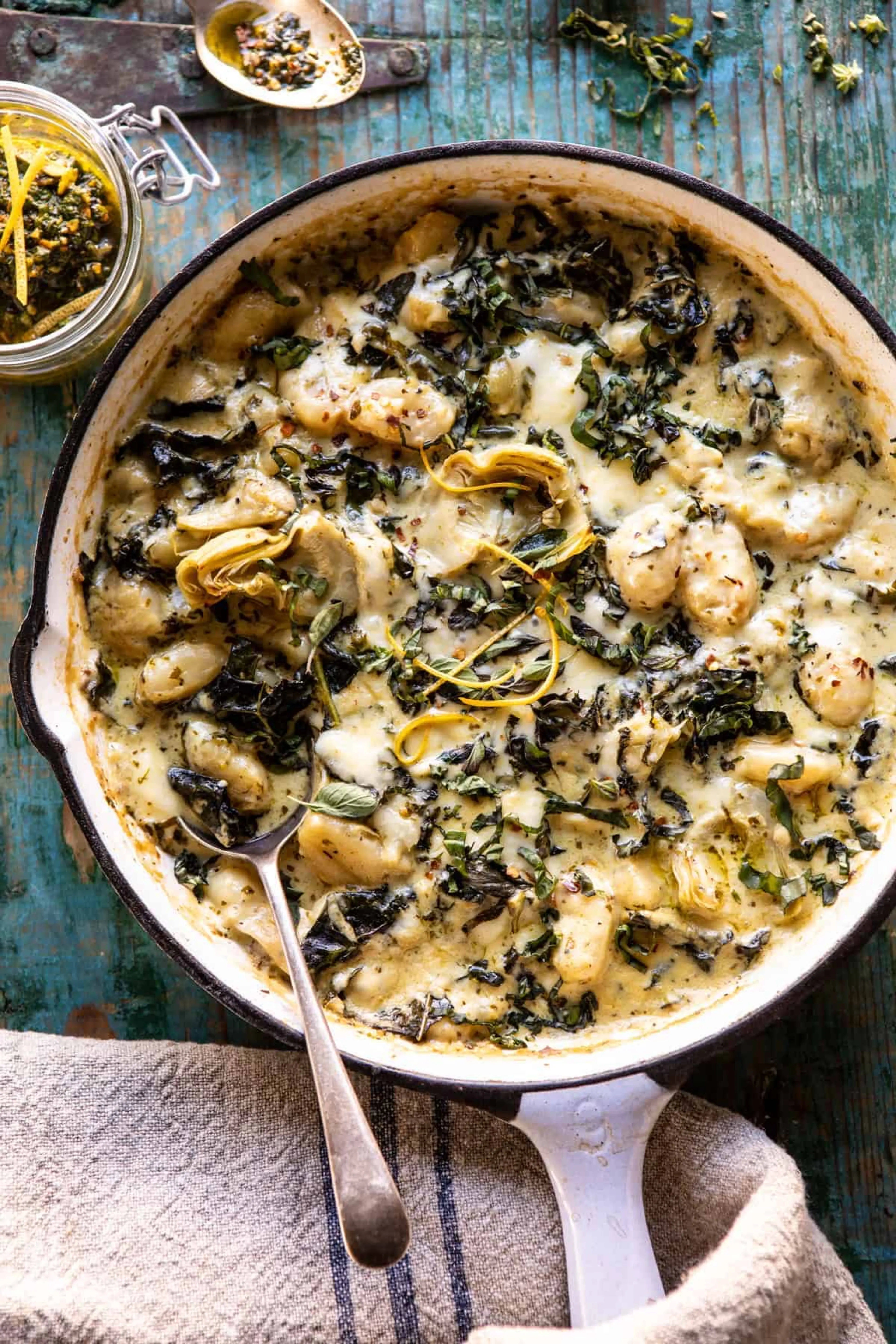 Skillet Baked Creamy Pesto Spinach and Artichoke Gnocchi.