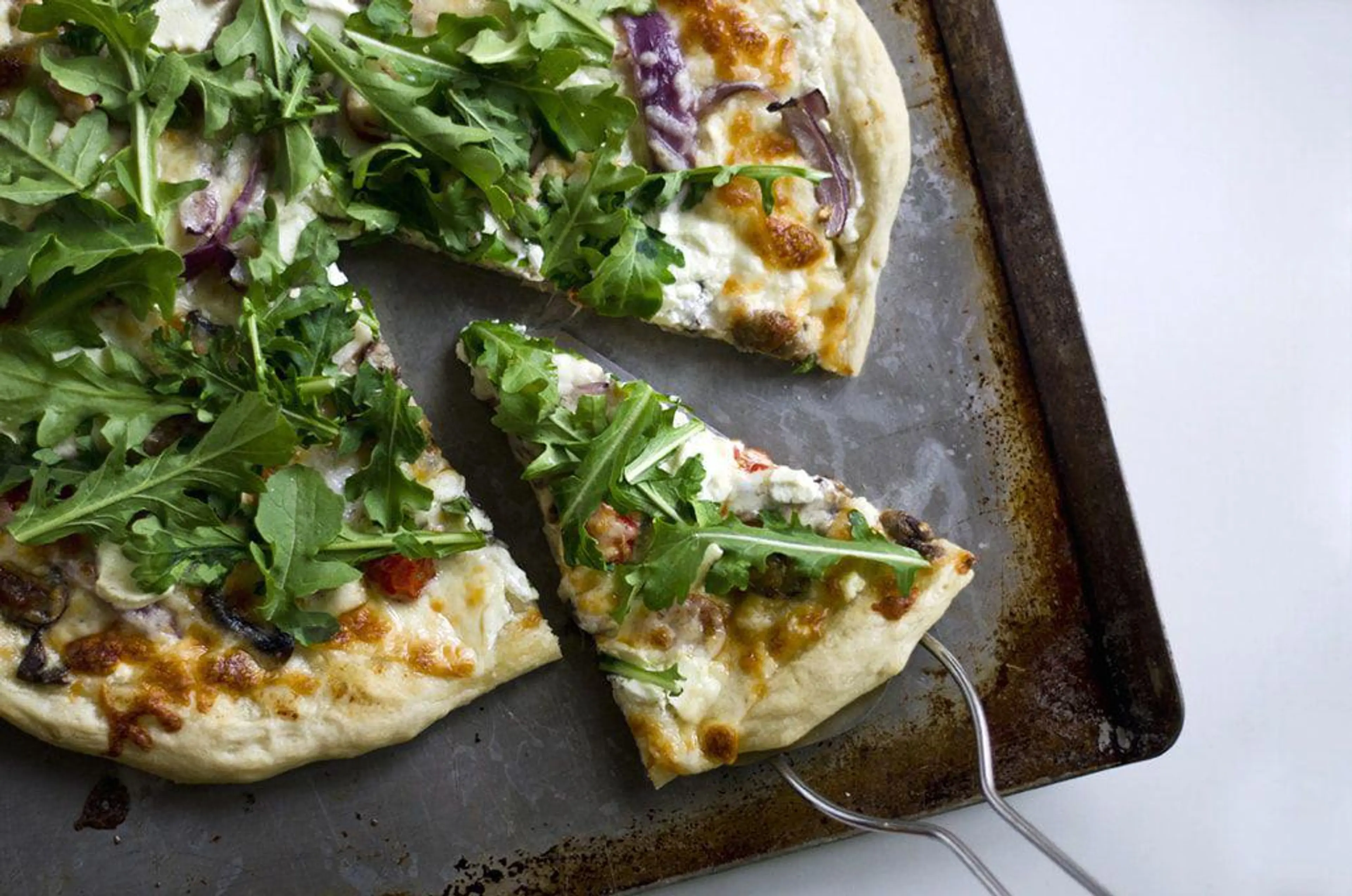 Goat Cheese Pizza with Arugula and White Sauce