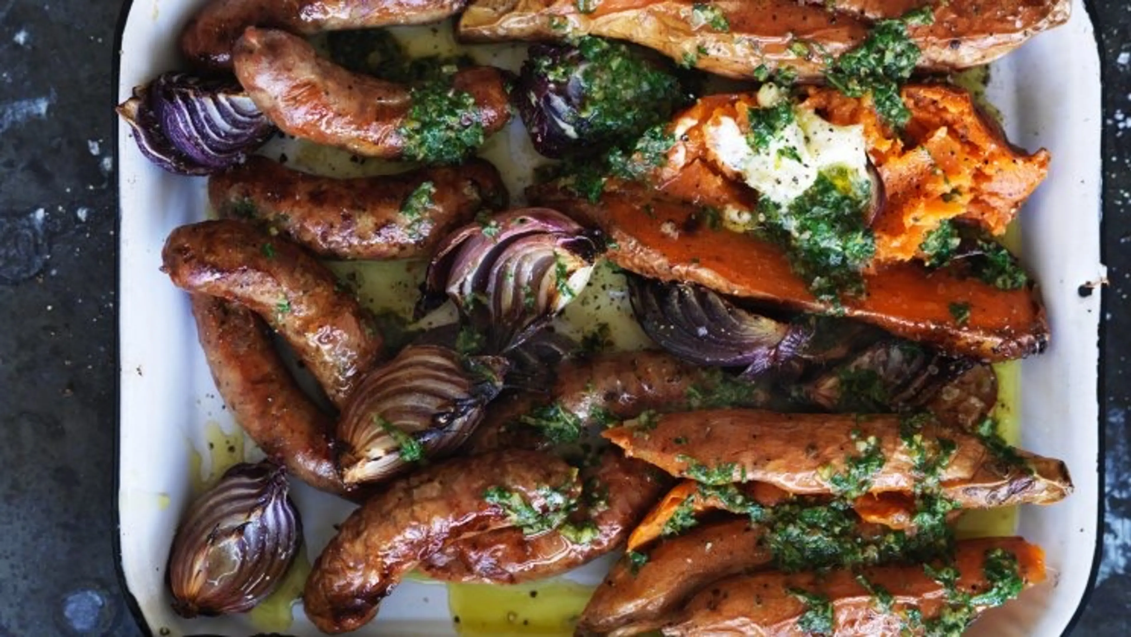 Baked sweet potato and sausages with salsa verde and sour cr