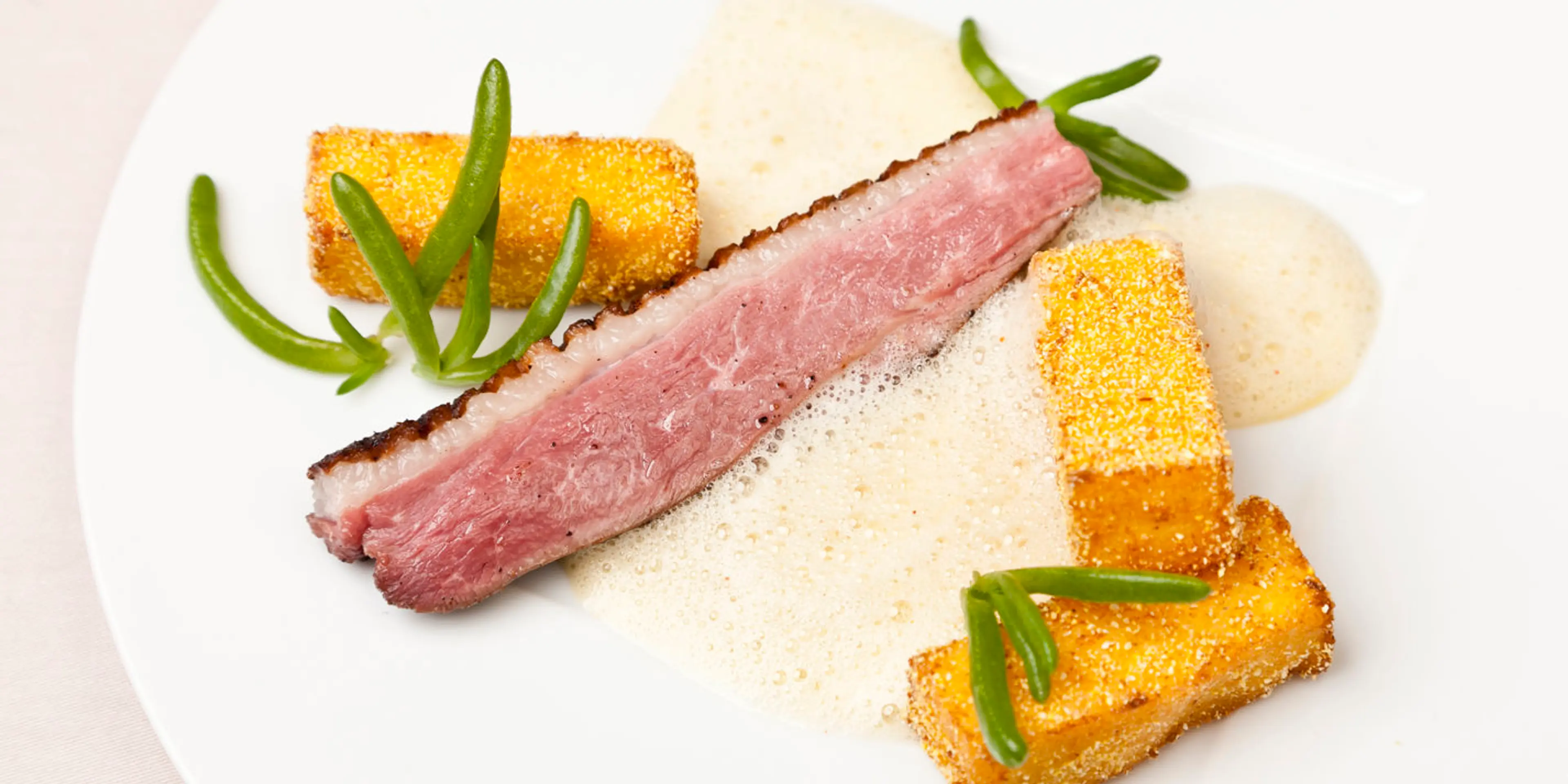 Duck breast with aromatic polenta fries and orange vinaigret