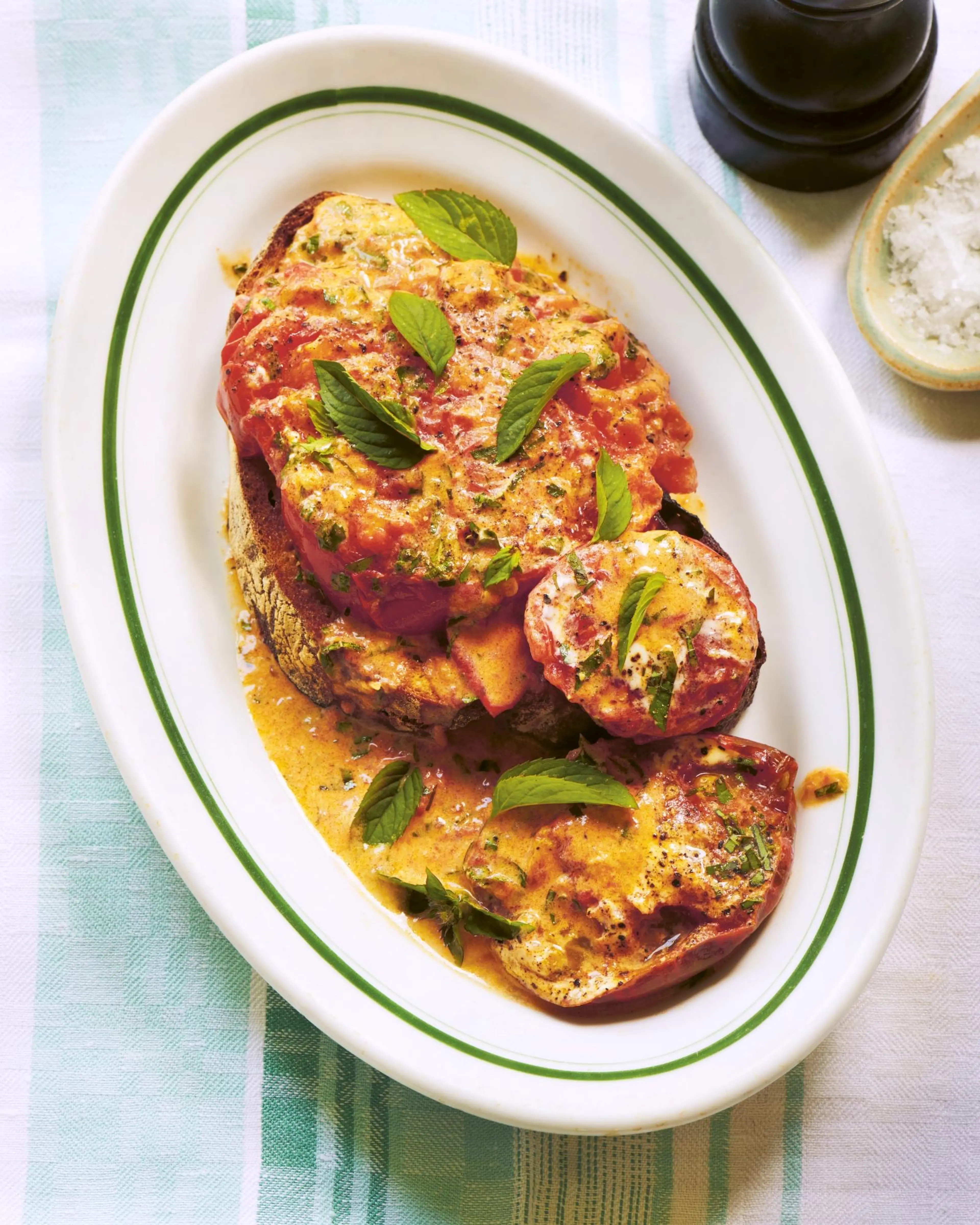 Tomatoes cooked in creme fraiche with mint on toast