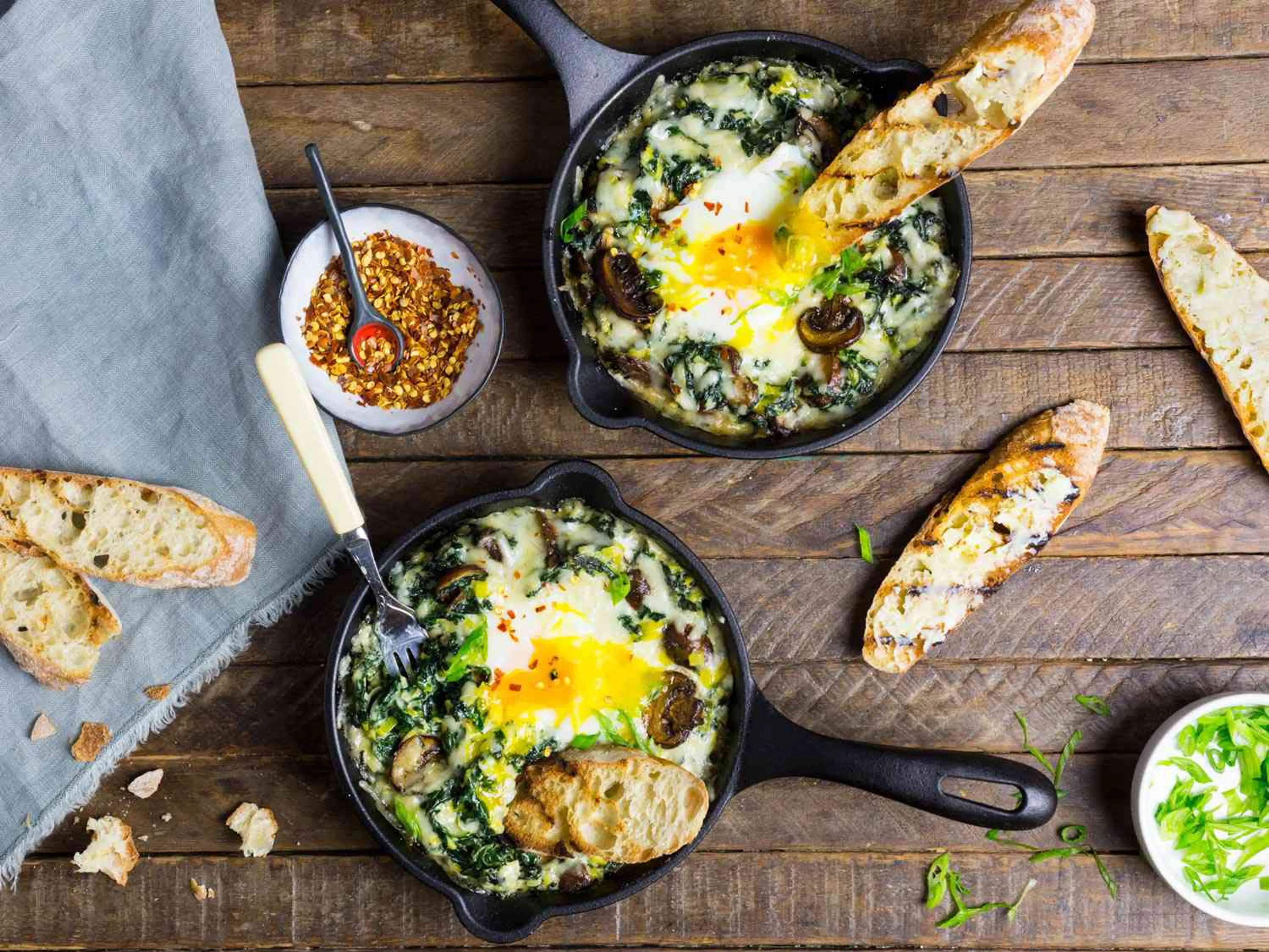 Baked Eggs With Creamy Greens, Mushrooms, and Cheese