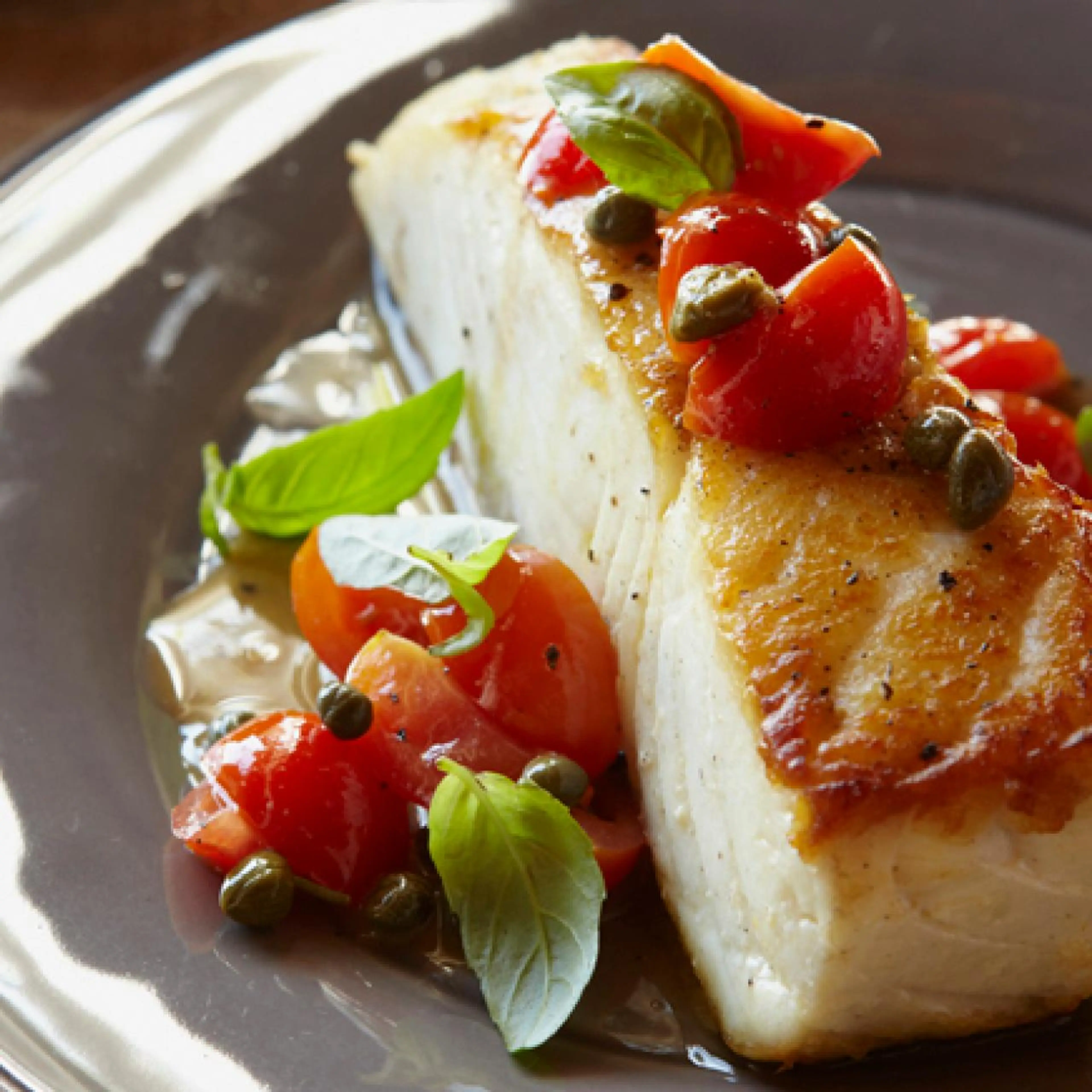 Halibut with Pepitas, Capers, Cherry Tomatoes, and Basil